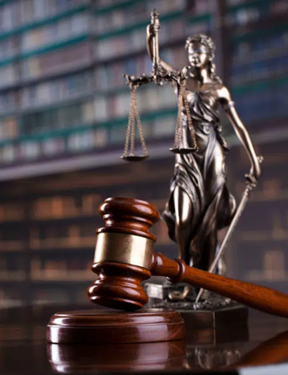 lady justice statue and judge gavel on a table in an attorney office